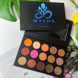 Tiger's Eye eyeshadow palette with natural brown, matte, shimmer, and glitter shades in a black case with mirror.