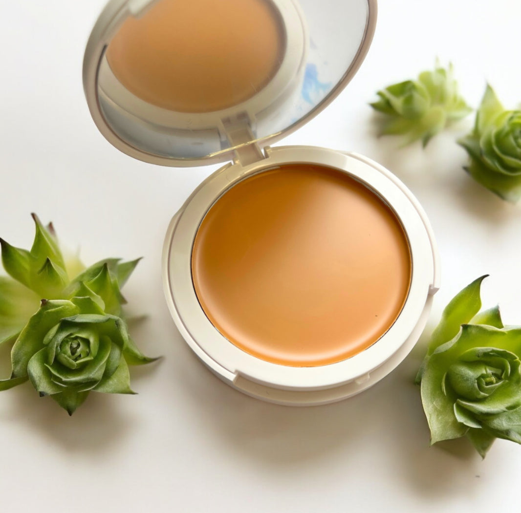 compact with Flawless Blend 2 in 1 foundation and concealer cream surrounded by green succulents for GlowUp CC Cream