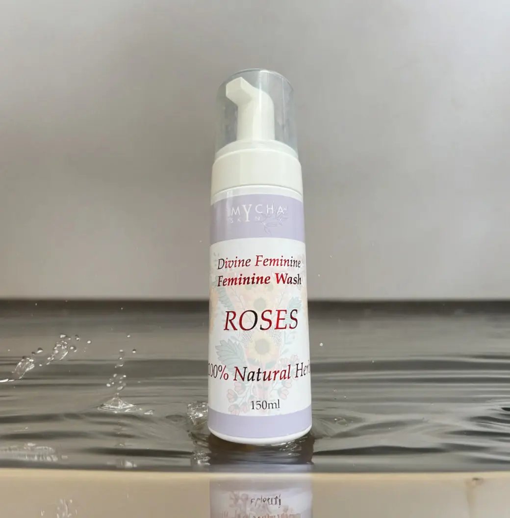 Divine Feminine Yoni Wash bottle with rose fragrance and natural herbal formula on water surface